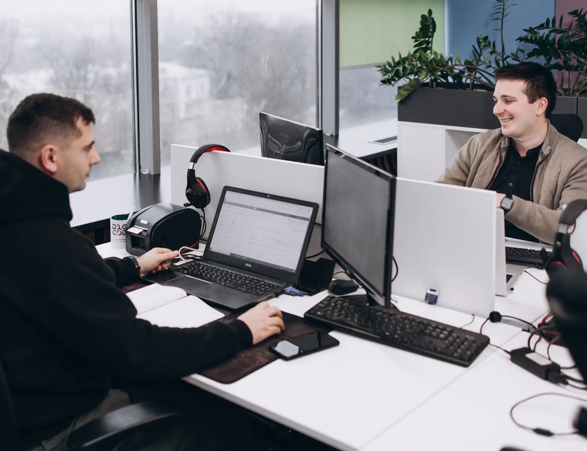 two smiling developers during work